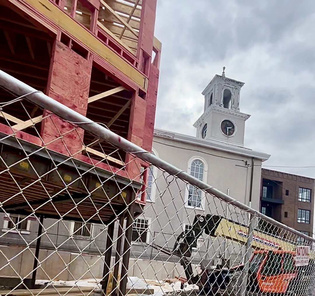five story condo goes up to the north sandwiching Chestnut Hill Baptist Church between a multi-story condo to the south